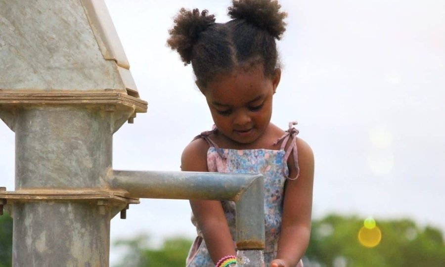 girl-washing-her-hands-at-a-water-well-in-burkina-faso-africa-e1659542851666.jpg